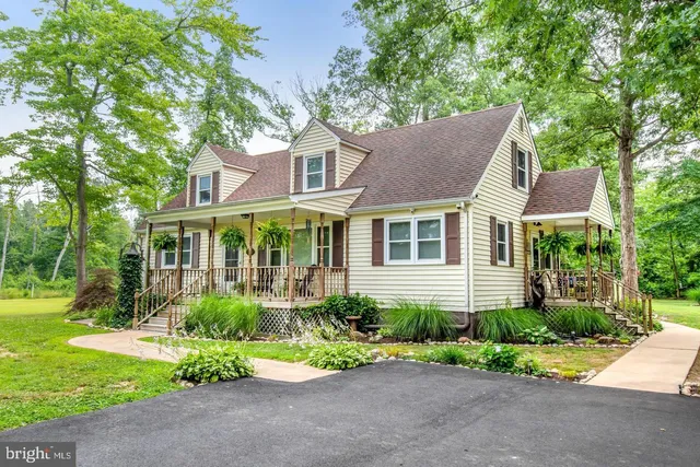 a front view of a house with a yard and potted plants