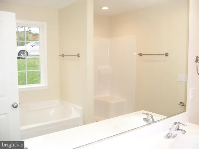 a bathroom with a bathtub and shower