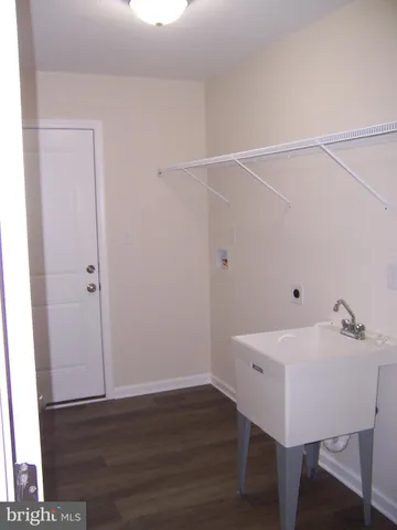 a view of a room with wooden floor and fan