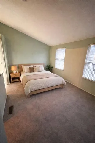 a bedroom with a bed and window