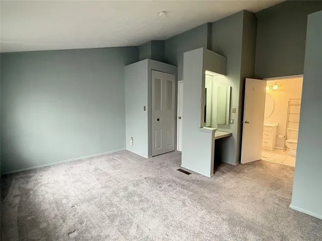 an empty room with large windows