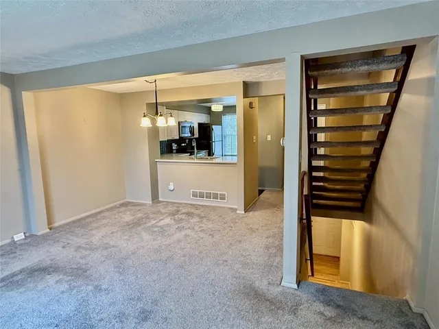 a view of hallway with stairs and furniture
