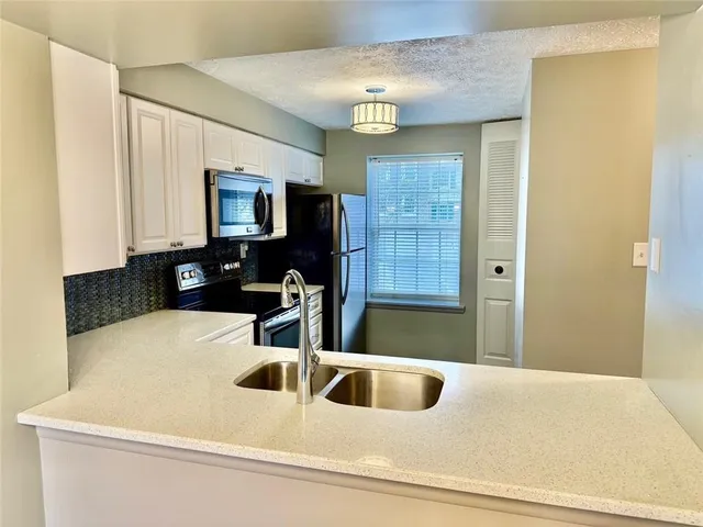 a kitchen with a sink and a refrigerator