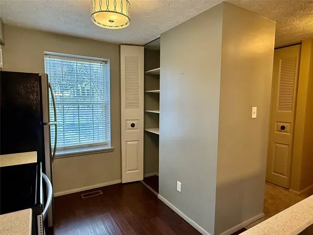an empty room with windows and closet