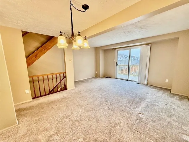 a view of a livingroom with a ceiling fan and window