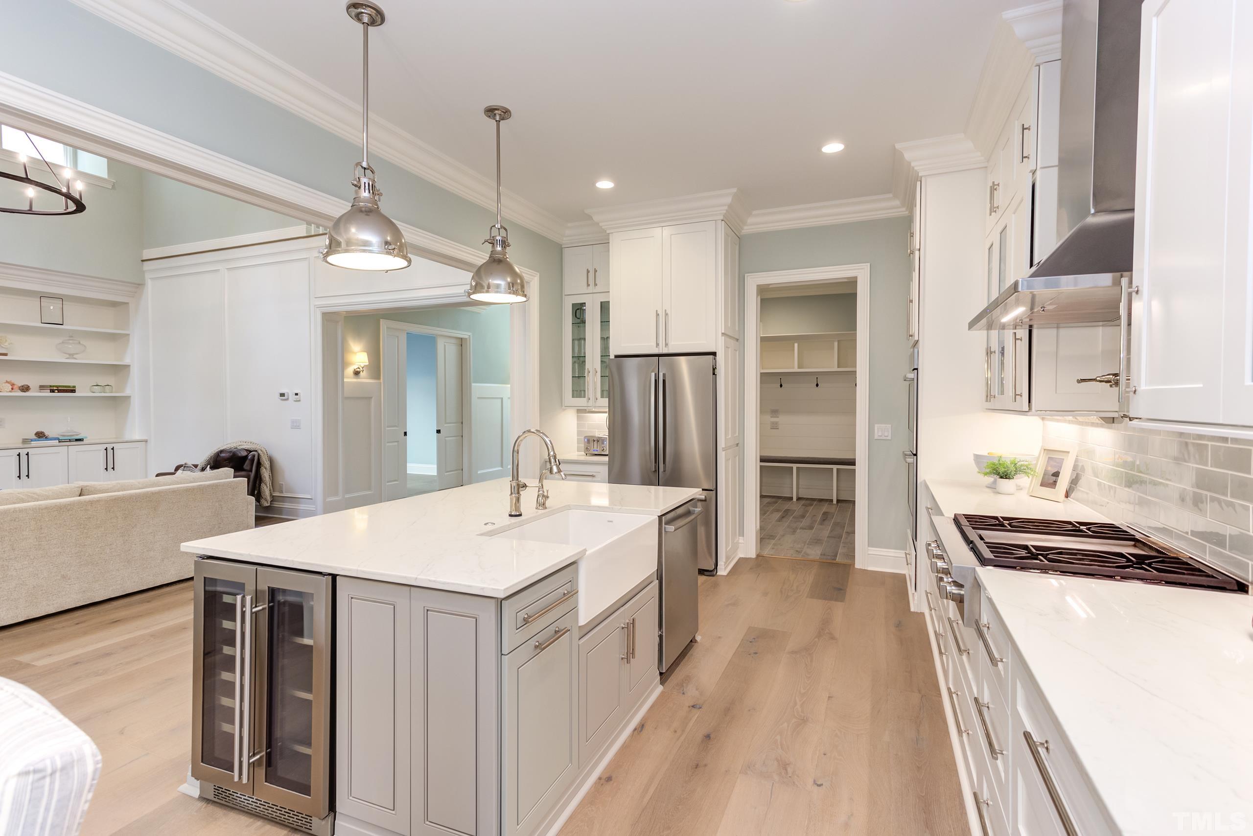 8009 Ghost Pony Trail Raleigh, NC 27613 - Photo 15 of 55 a large white kitchen with a large window a sink and stainless steel appliances