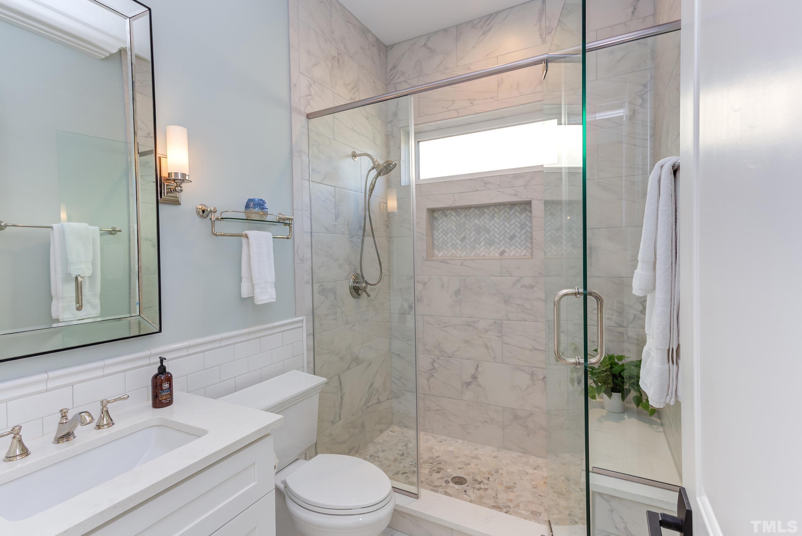 8009 Ghost Pony Trail Raleigh, NC 27613 - Photo 29 of 55 a bathroom with a sink vanity granite toilet and shower