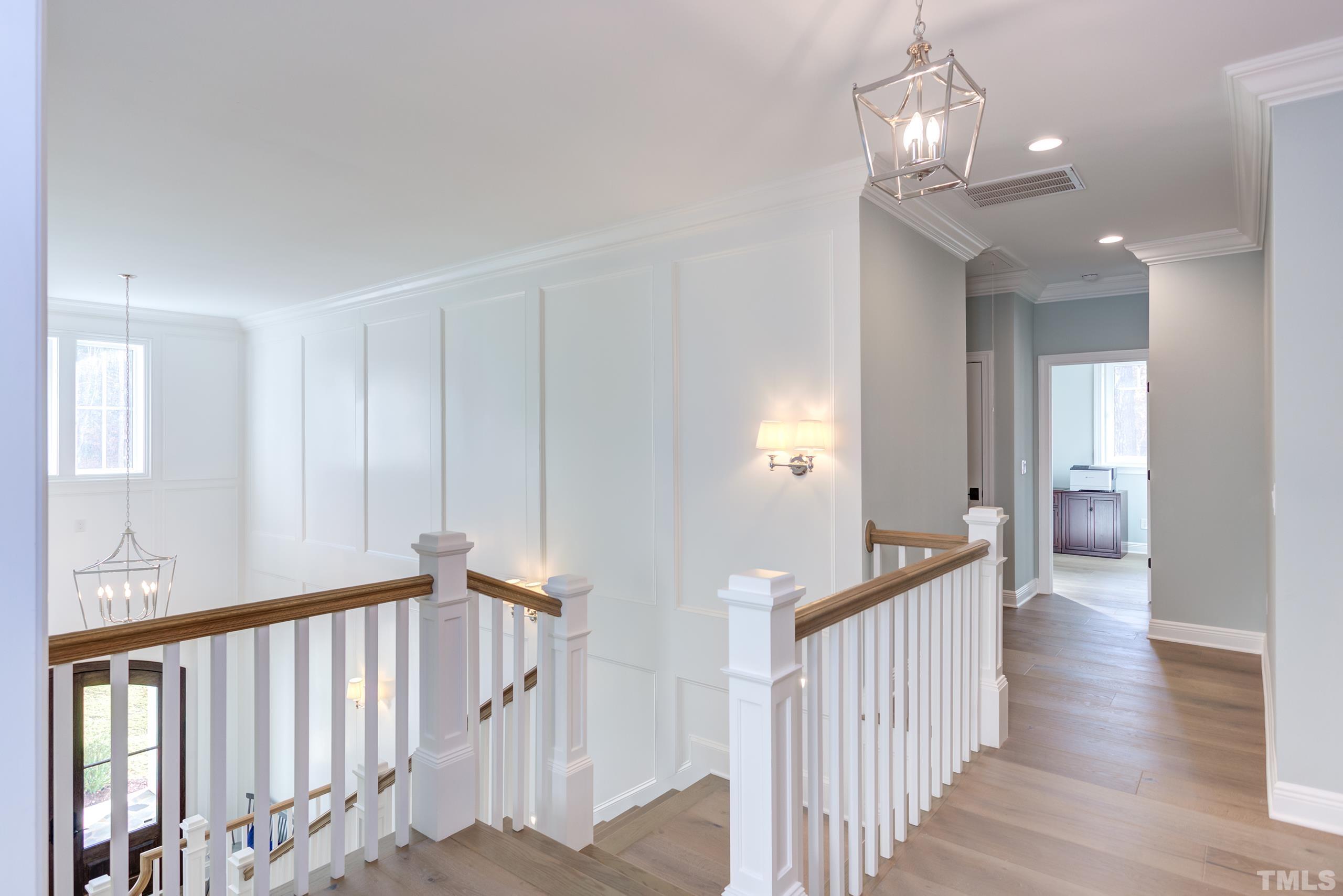 8009 Ghost Pony Trail Raleigh, NC 27613 - Photo 33 of 55 a view of a hallway with wooden floor and staircase