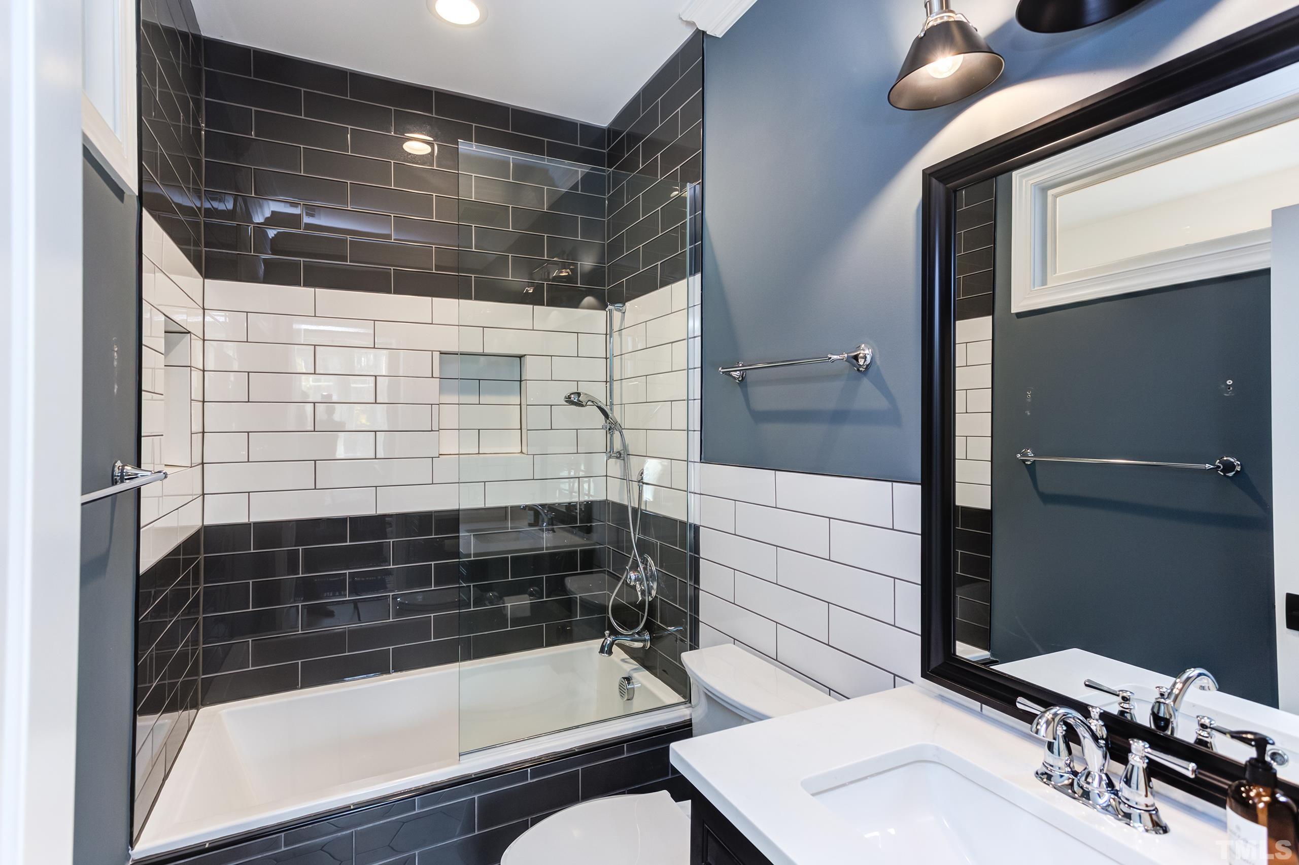 8009 Ghost Pony Trail Raleigh, NC 27613 - Photo 41 of 55 a bathroom with a sink and a shower