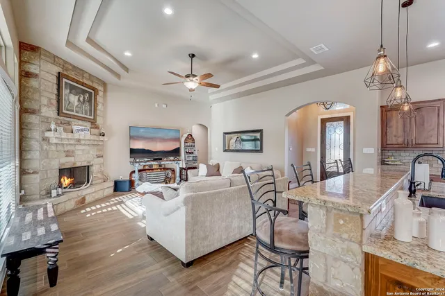 a kitchen with stainless steel appliances granite countertop a sink a stove and a refrigerator