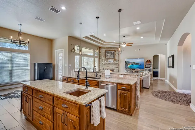 a bathroom with a granite countertop tub sink and mirror