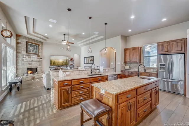 a spacious bathroom with a granite countertop sink a mirror and bathtub