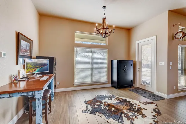 a bathroom with a granite countertop sink and a large mirror