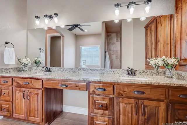 a bathroom with double vanity sinks and a mirror
