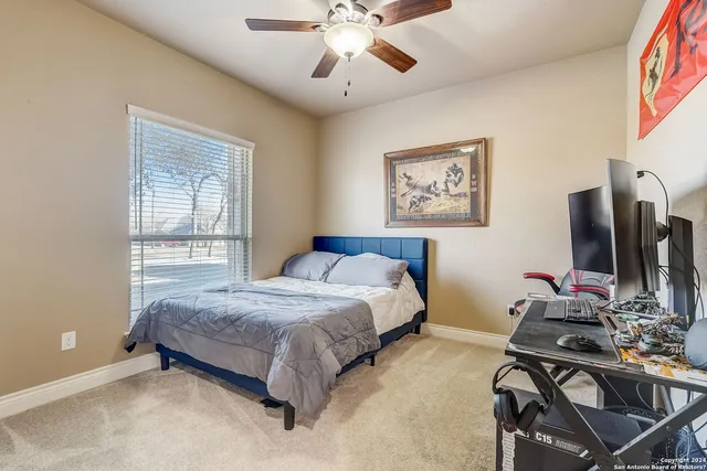 a bedroom with a bed and a desk