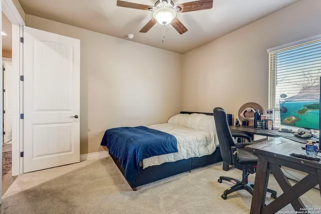 an aerial view of a house with pool garden and outdoor seating