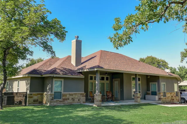 a view of a green field with lots of bushes and trees
