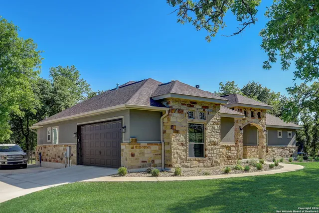 a living room with furniture large window and a fireplace