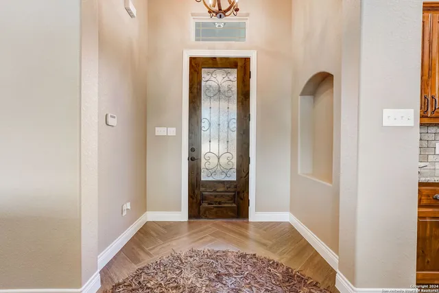 a living room with fireplace furniture and a wooden floor