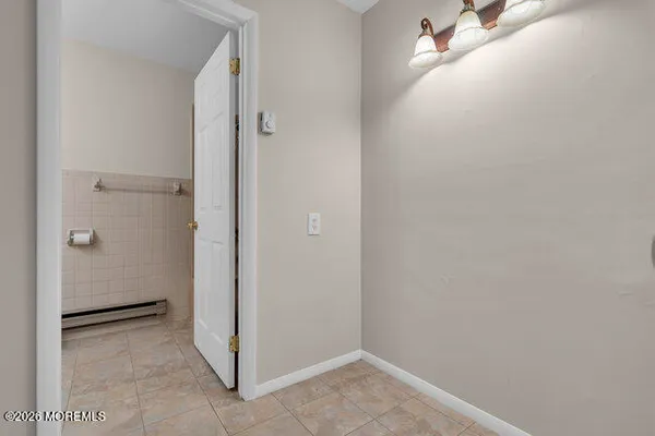 a kitchen with granite countertop white cabinets white stainless steel appliances and a sink
