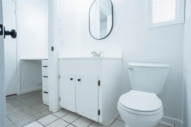 a bathroom with a toilet and a mirror