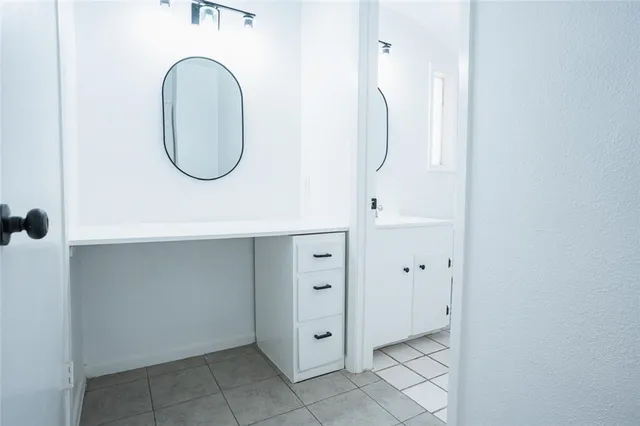 a bathroom with a mirror a sink and a mirror