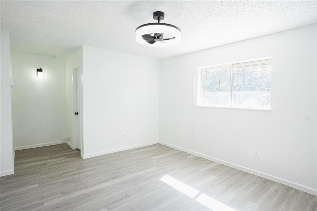 4509 Hogan Street Corpus Christi, TX 78413 - Photo 17 of 27 an empty room with wooden floor and windows