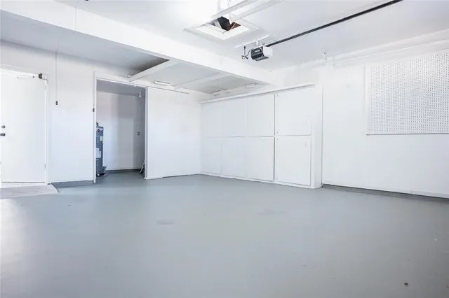 an empty room with a ceiling fan and entryway