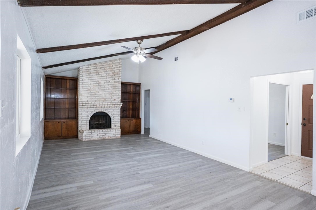 4509 Hogan Street Corpus Christi, TX 78413 - Photo 5 of 27 a view of a livingroom with wooden floor and a fireplace