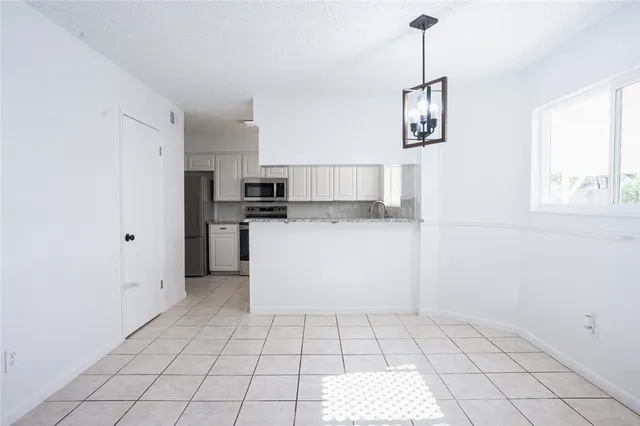 a utility room with cabinets washer and dryer