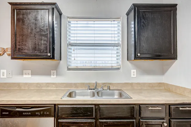 a close view of a sink and a cabinet in a kitchen