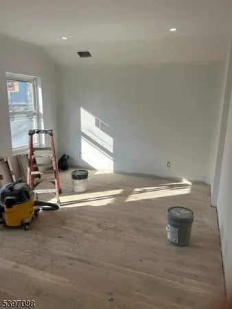 a view of hallway with wooden floor
