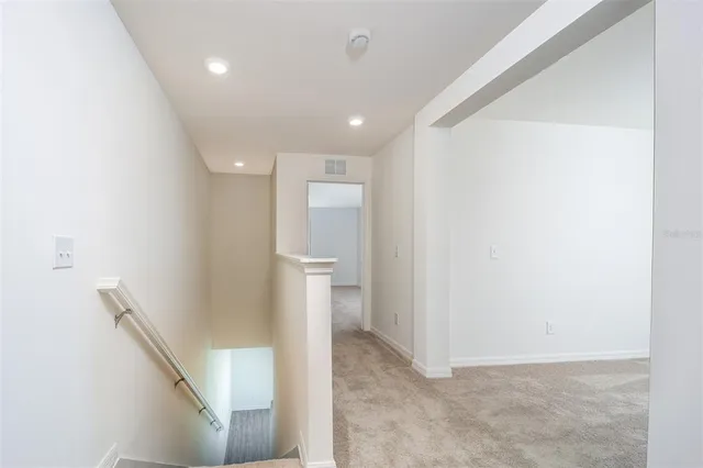 a view of a hallway with a white walls