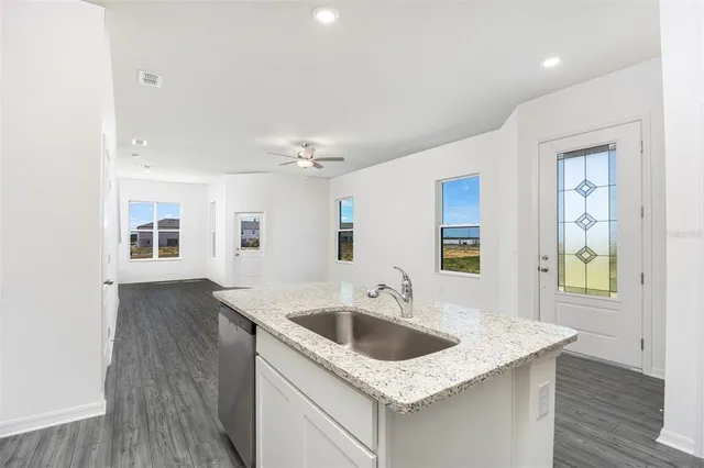 a kitchen with sink and mirror