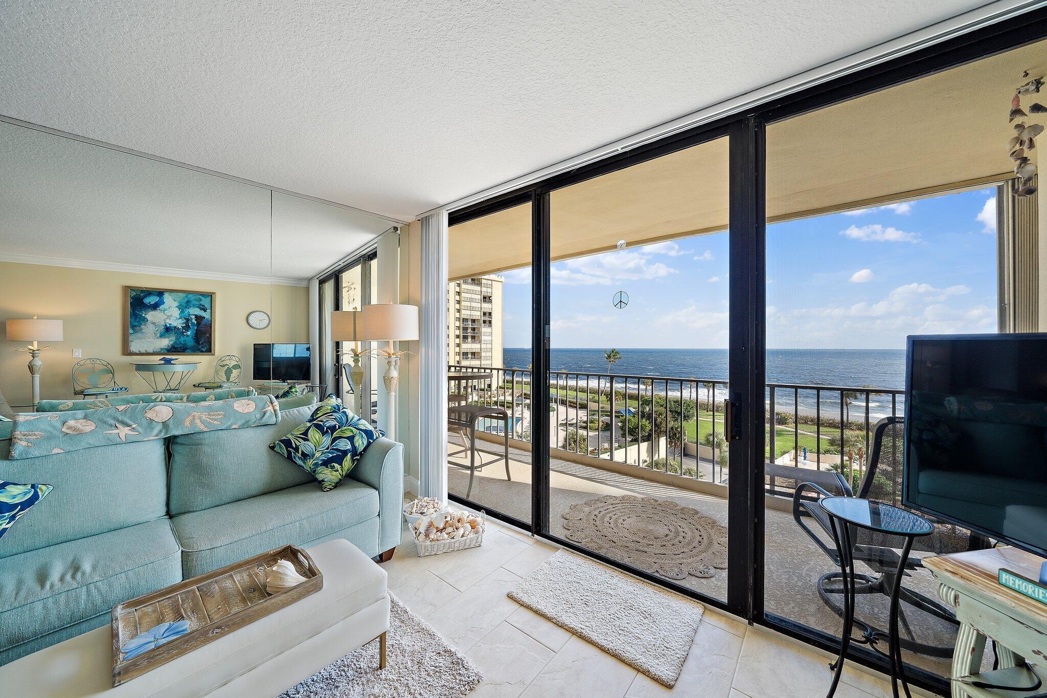 100 Ocean Trail Way, Unit 609 Jupiter, FL 33477 - Photo 7 of 66 a living room with furniture and a flat screen tv