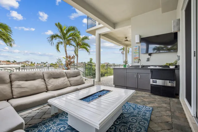 a living room with furniture and a view of kitchen