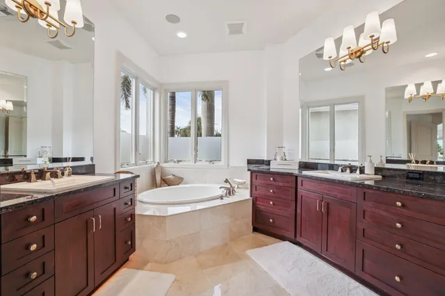 a spacious bedroom with a bed a table and large window