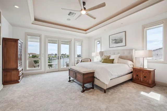 a spacious bedroom with a bed and a flat screen tv