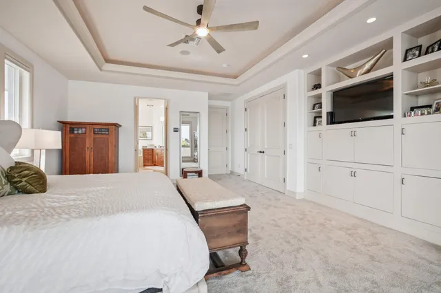 a bathroom with a granite countertop tub sink and mirror