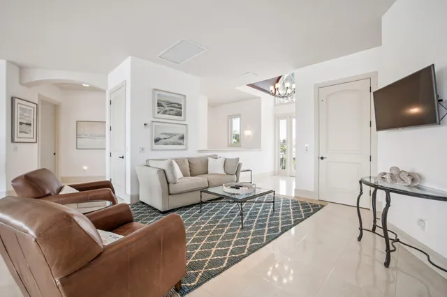 a spacious bedroom with a bed a couch and a ceiling fan