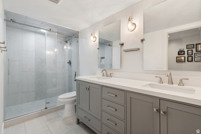 1567 Ridgeview Circle Farmington, UT 84025 - Photo 33 of 55 Walk-in shower with clear glass barn door and tiled surround