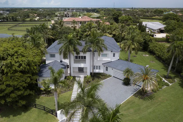 an aerial view of residential houses with outdoor space and river