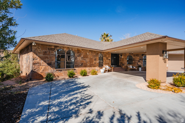 980 Cactus Circle St. George, UT 84790 - Photo 69 of 77 View of front facade featuring stone siding, a shingled roof, and a patio area