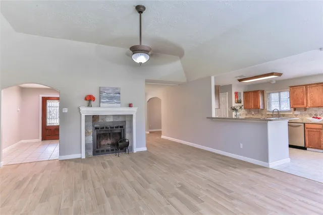 a large kitchen with stainless steel appliances a sink and cabinets