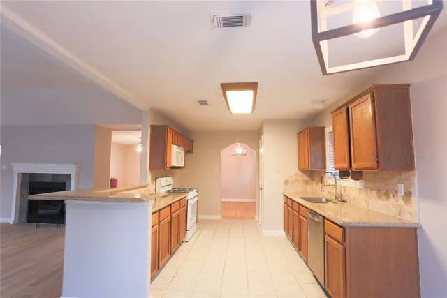 a large kitchen with kitchen island granite countertop a large window