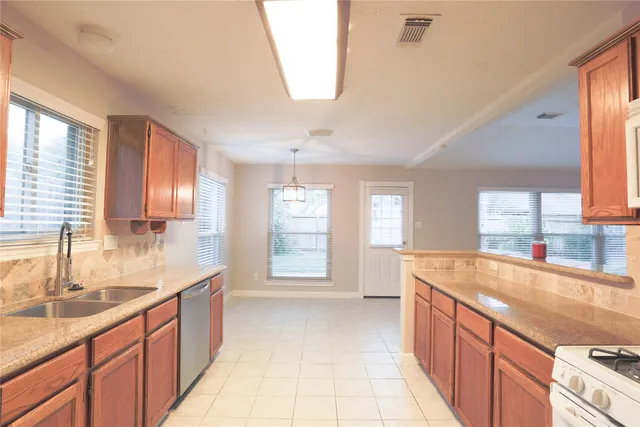 a bathroom with a granite countertop double vanity sink a mirror and a bathtub