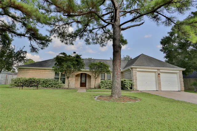 a front view of a house with a garden and yard