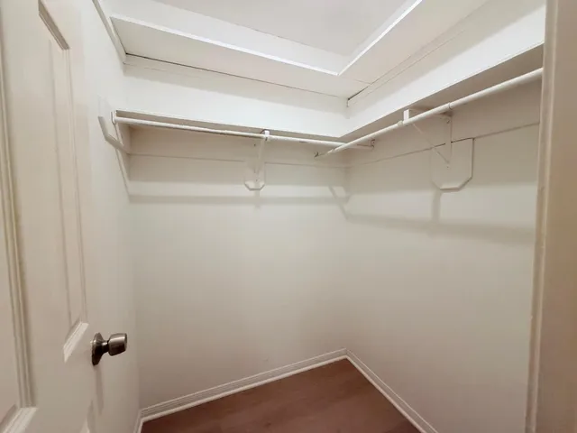 a view of a yard in front of a house with large trees