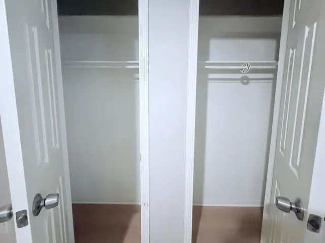 a view of a swimming pool with lawn chairs under an umbrella