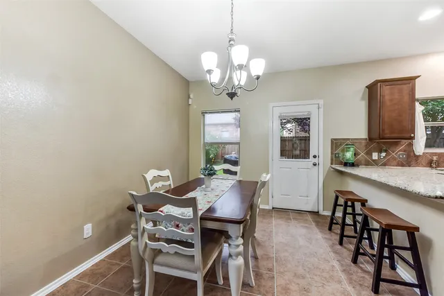 a view of a dining room with furniture and a chandelier